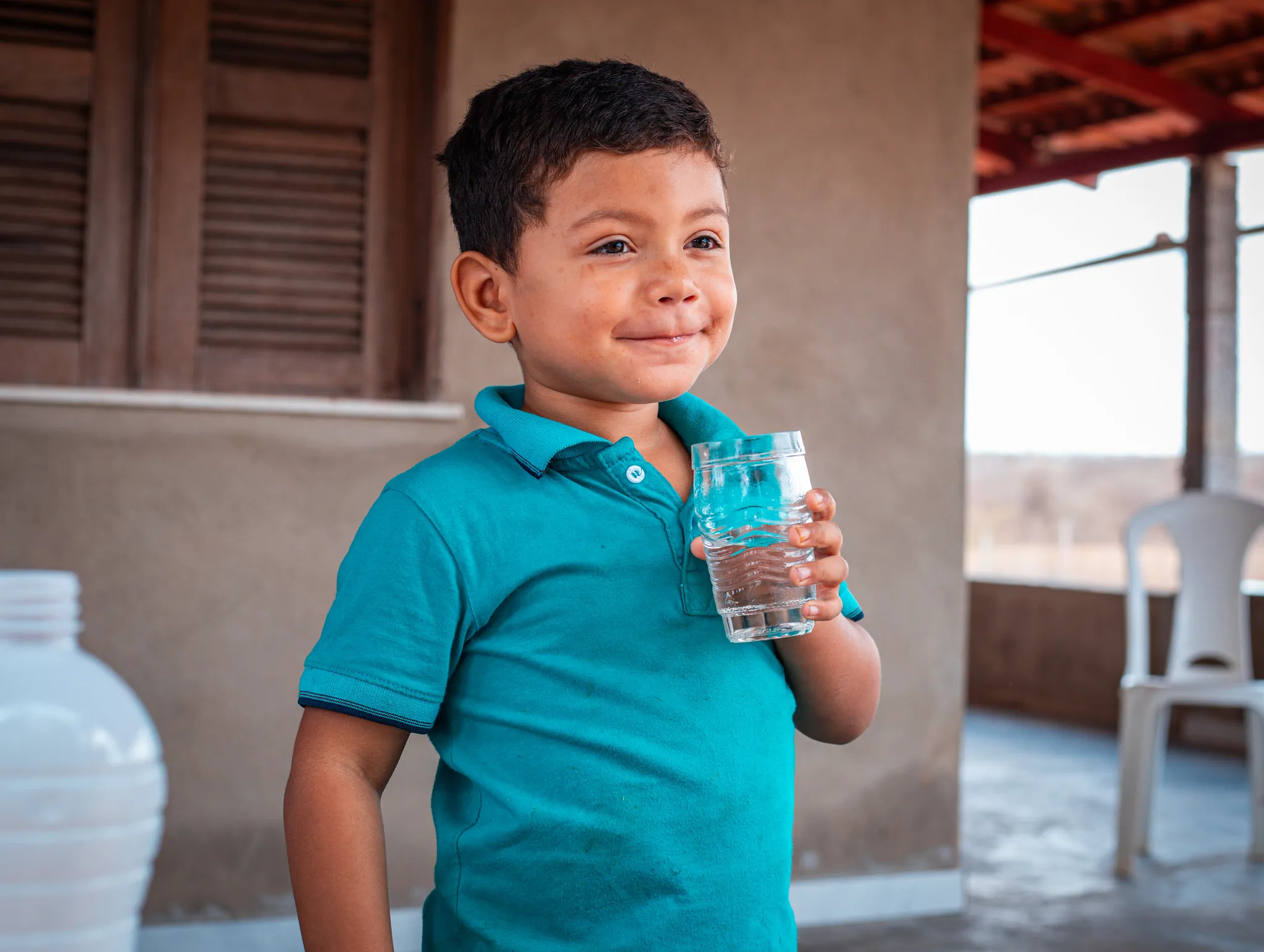 Gecilda's son holding water glass